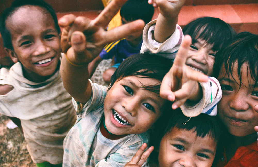 A group of happy less privileged children posing for a photograph